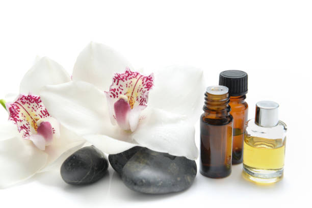 istock oil bottles and pebbles with beautiful orchids 1208779604