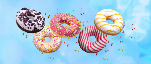 istock Flying doughnuts. Sweet and colourful donuts on blue background . 1208780176