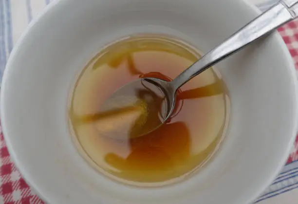 Vinaigrette in a bowl  Oil and vinegar flavored with walnuts