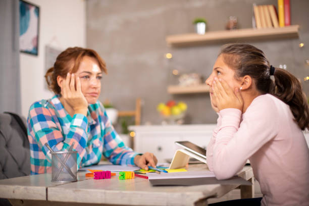 istock Mother helping daughter with homework. 1208780940