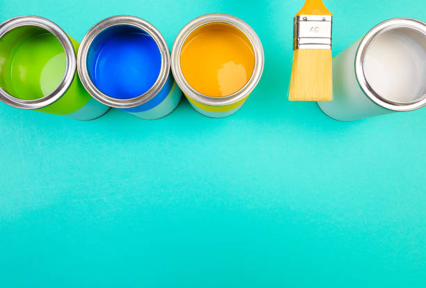 istock Metal paint cans and paint brush on color background. Top view. Copy space 1208782813