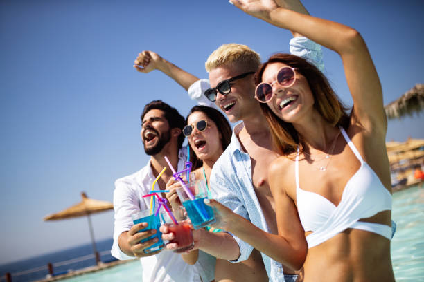 istock Summer party. Friends at beach drinking coctails and having fun 1208783837