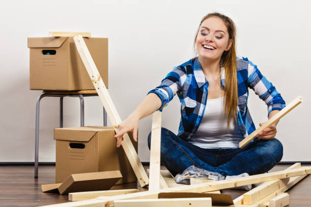 istock Woman moving into apartment house. 1208786957