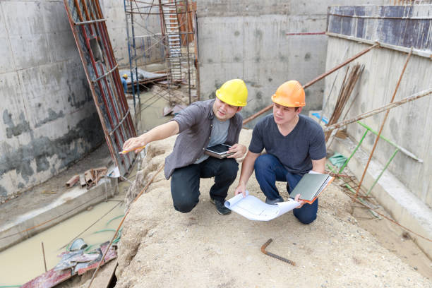 istock Portrait Of Men Wearing Hardhat Working At Construction Site 1208787482