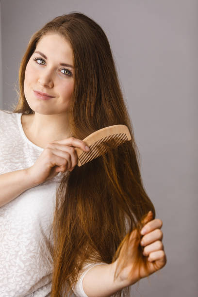 istock Happy woman brushing her hair 1208789034