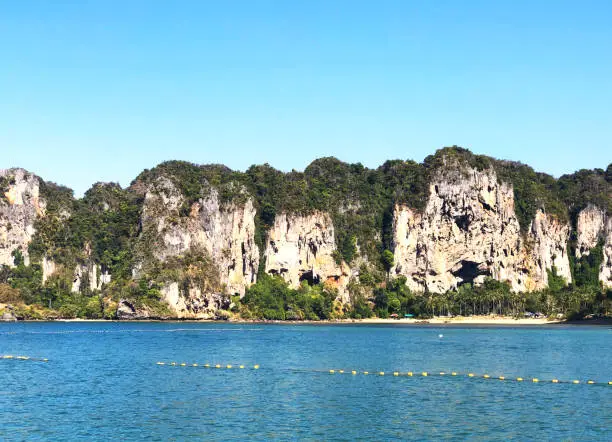 Aonang, Krabi / Thailand - February 11, 2019: Aonang Beach, the beautiful and famous place in Thailand. Blue sky cloudy, mountain and green sea with long tail boats, good for the vacation season.