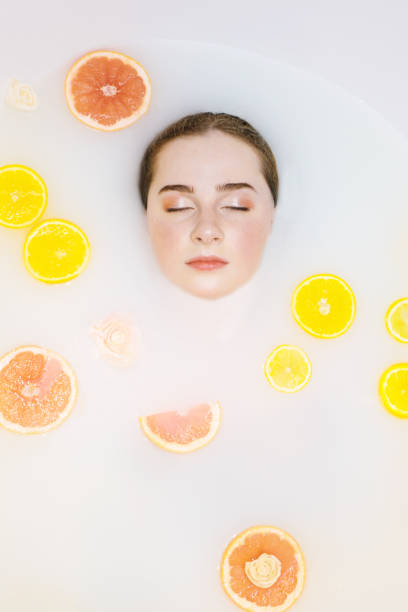 istock Pretty girl in bath with orange lemon. 1208792008