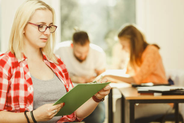 istock Student girl in front of her mates in classroom 1208792439