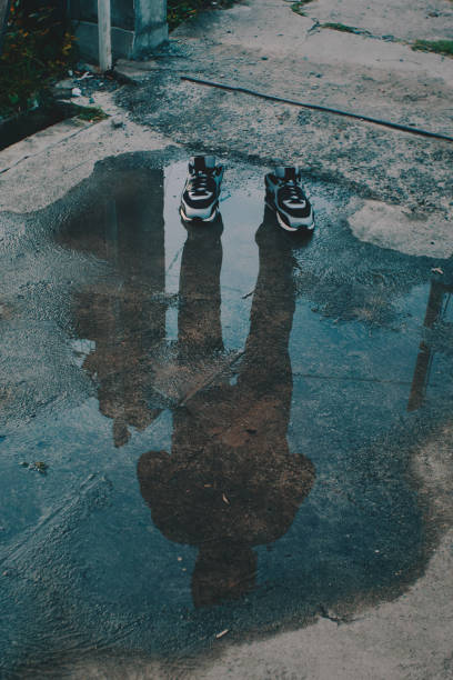 istock shadow of a man with hoodie 1208794057