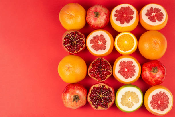 istock Grapefruit, orange, pomegranate, citrus sweetie on red background. 1208795128