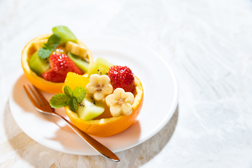 Delicious fruits in plate on a festive table