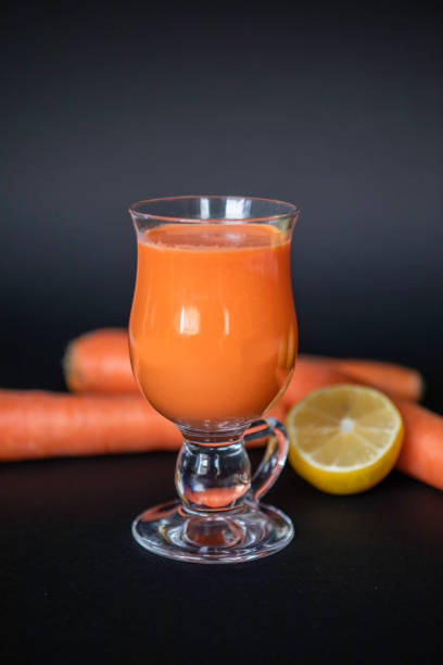 Juice in the glass surrounded by fresh vegetables and fruits stock photo