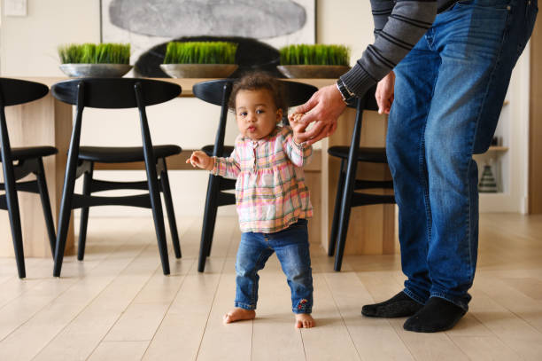 istock Baby girl first steps 1208799369