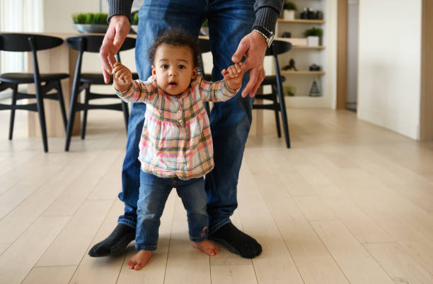 istock Baby girl first steps 1208799380