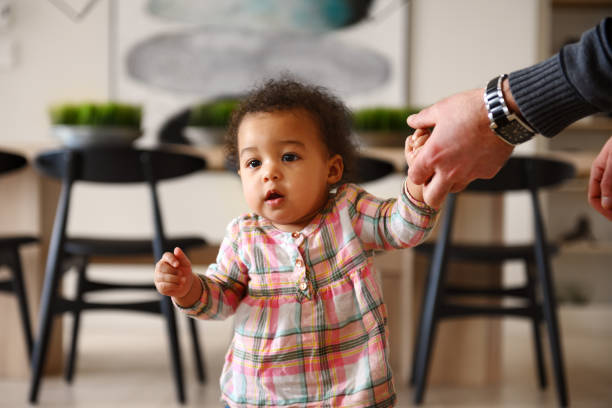 istock Baby girl first steps 1208799392