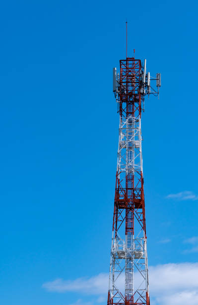 istock Telecommunication tower with blue sky and white clouds background. Antenna on blue sky. Radio and satellite pole. Communication technology. Telecommunication industry. Mobile or telecom 4g network. 1208799639