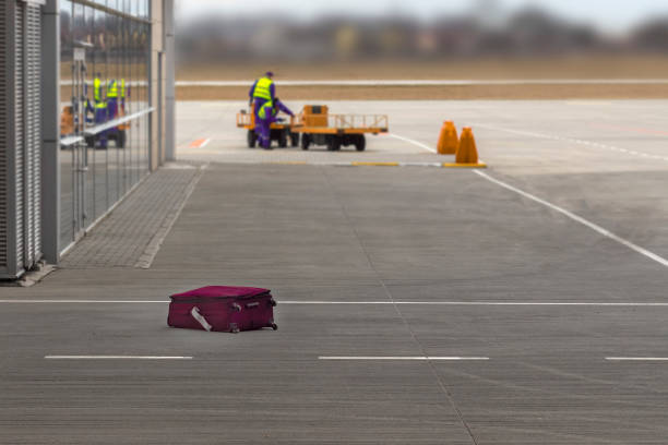 The suitcase lost by the airport staff lies on the floor. Concept of lost luggage. stock photo