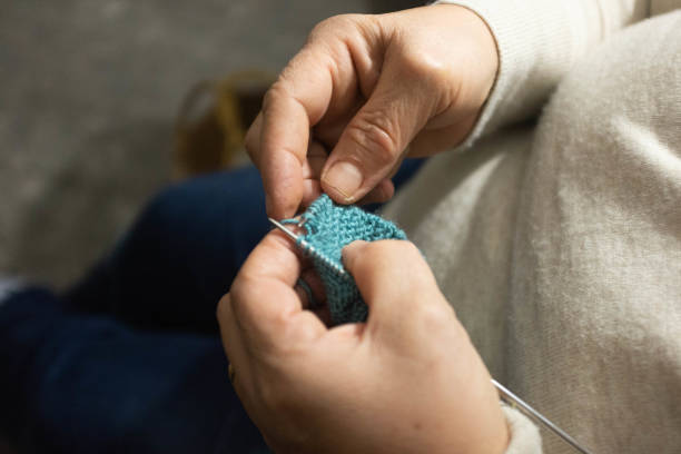istock Woman knitting scarf 1208802640