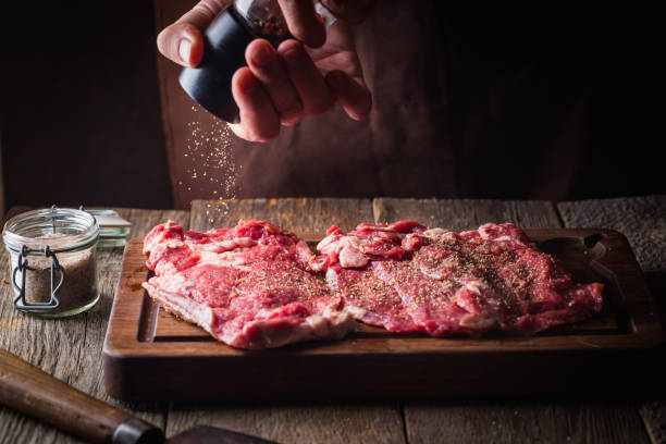 istock Man cooking meat steaks 1208804406