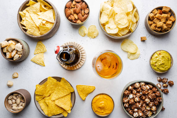 veraity bowls of beer snacks - beer nuts imagens e fotografias de stock