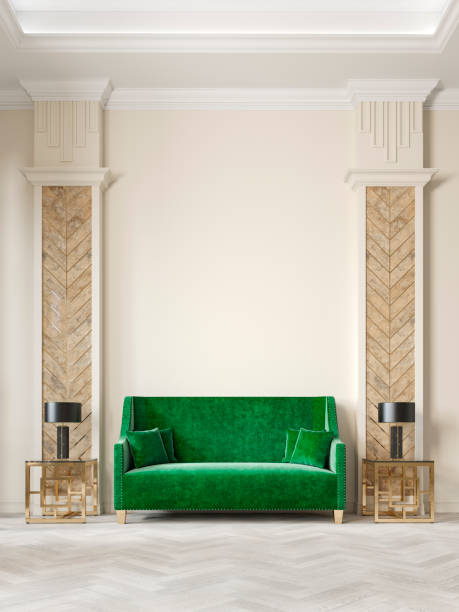Art deco style beige interior with green sofa, columns, table lamp, moldings.