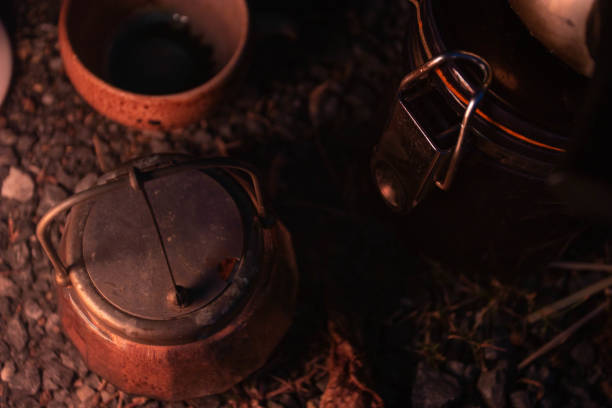 istock Coffee and candlelight on the grass of the night 1208806936