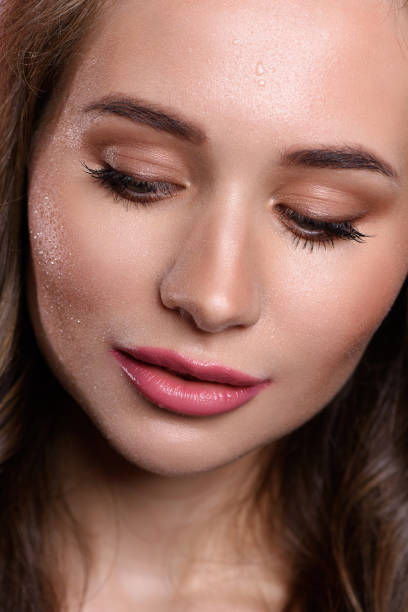 istock Beautiful girl with pearls make-up, pink lips. 1208807703