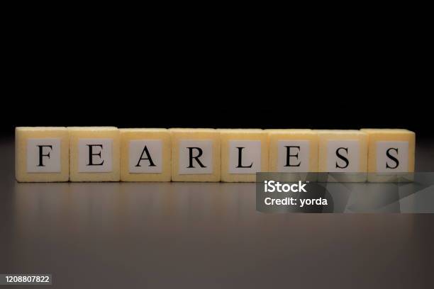 The Word Fearless Written On Wooden Cubes Isolated On A Black Background Stock Photo - Download Image Now