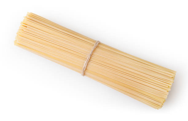istock Uncooked spaghetti isolated on white background with clipping path 1208808506