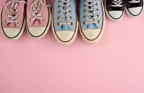 istock many multi-colored well-worn textile sneakers of different sizes on a pink background 1208808659