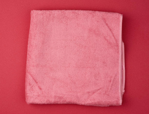 istock folded bath terry pink towel on a red background 1208809499