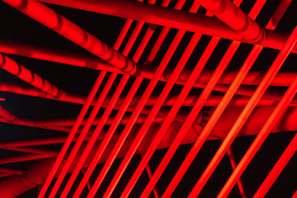 The illuminated structure of the Seri Saujana Bridge at night. One of many bridges in Putrajaya, Malaysia, all alternately illuminated in unison in different colors. Putrajaya Bridge Malaysia at night