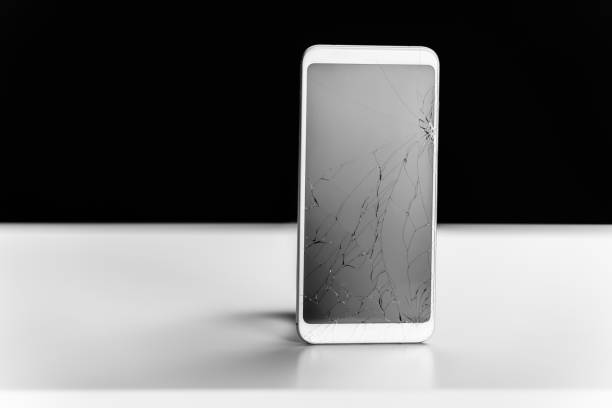 istock Smartphone with cracked screen on black and white background 1208810081