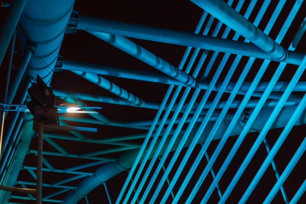 The illuminated structure of the Seri Saujana Bridge at night. One of many bridges in Putrajaya, Malaysia, all alternately illuminated in unison in different colors. Putrajaya Bridge Malaysia at night