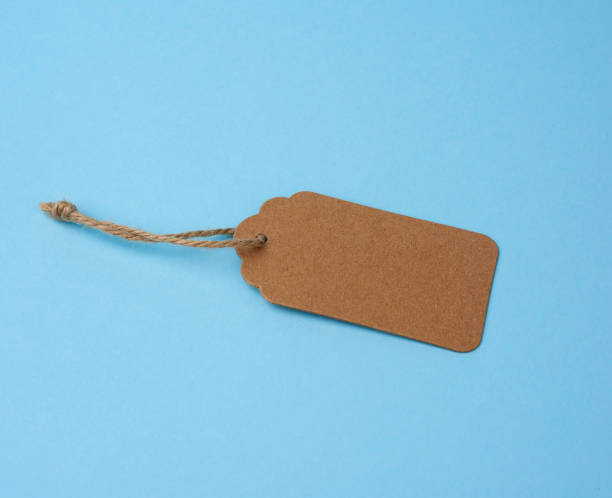 istock Empty brown paper tag tied with white string. Price tag 1208810492