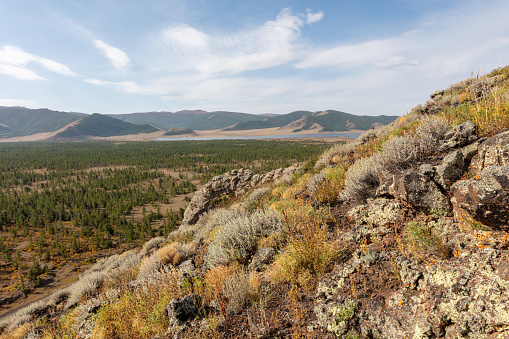 A view from the mountains to the big Terkhiin Tsagaan Lake or white lake in the Khangai Mountains in central Mongolia. The Khorgo volcano is located near the eastern end of the lake.