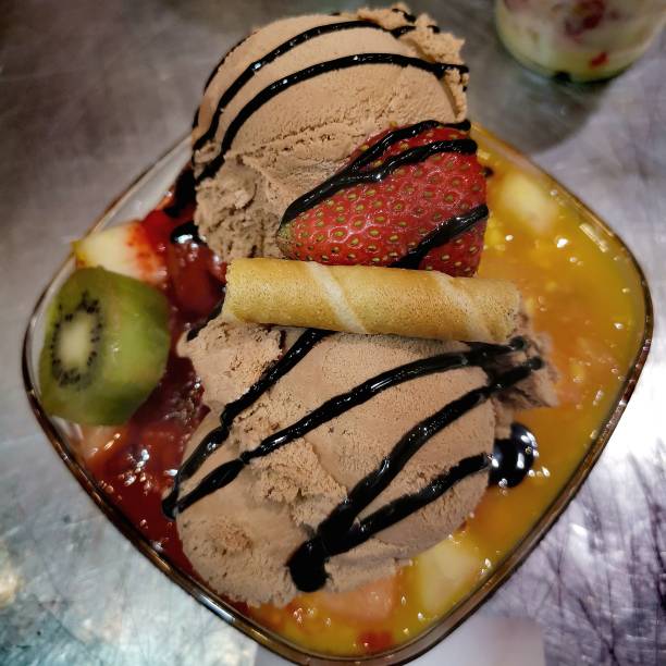 istock Fruit salad with ice cream chocolate with honey and nuts 1208812960