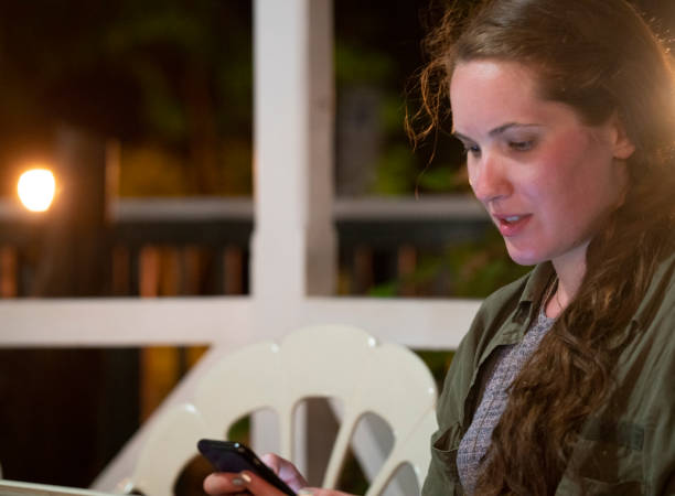 istock Young woman with mobile device, soft focus 1208813790