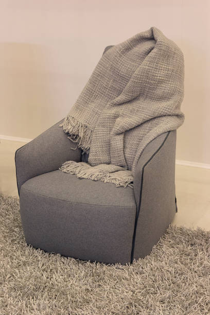 istock Comfortable modern chair and a cozy blanket. Interior 1208814734