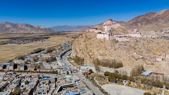 City of Xigaze, Tibet, China.  Shigatse the second largest city of tibet. View to the castle or Dzong from the sky . Aerial photography. Mountain of Himalaya. destroyed during cultural revolution. Shigatse is the second largest city of tibet. the castle or Dzong from the sky