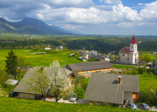Rural alpine landscape with slovenian village in valley near Bled lake at spring sunny day