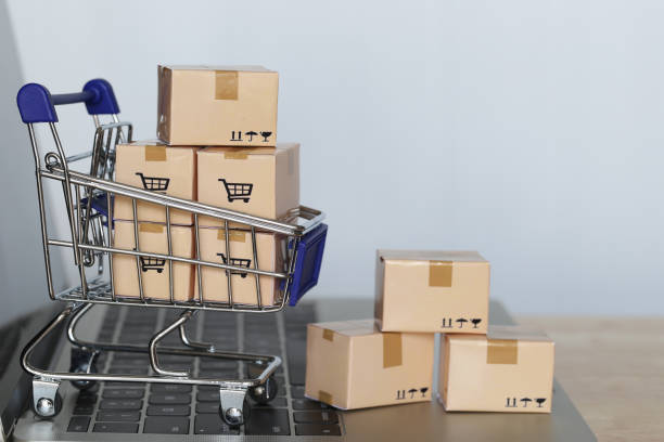 istock Brown parcel box and Model miniature shopping cart on computer keyboard for online shopping 1208817717