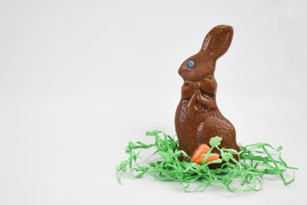 Chocolate Easter Bunny With Green Grass Isolated Over White Background Chocolate Easter Bunny Candy With Green Grass Isolated Over White Background chocolate bunny stock pictures, royalty-free photos & images