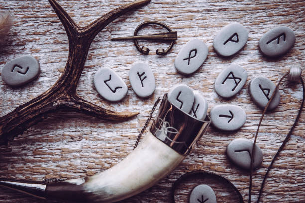 Flat lay view of rune stones with various viking era style objects. Ancient divination and vikings lifestyle concept. Flat lay view of rune stones with various viking era style objects. Ancient divination and vikings lifestyle concept. runes stock pictures, royalty-free photos & images