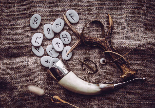 Flat lay view of rune stones with various viking era style objects. Ancient divination and vikings lifestyle concept. Flat lay view of rune stones with various viking era style objects. Ancient divination and vikings lifestyle concept. runes photos stock pictures, royalty-free photos & images