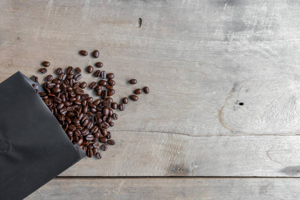 istock coffee bean on wooden background. top view 1208820739