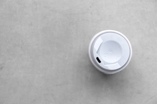 istock paper cup and hot coffee on cement floor background. top view 1208820758