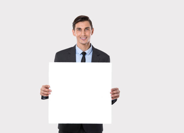 istock Businessman Holding a Blank Placard 1208820997