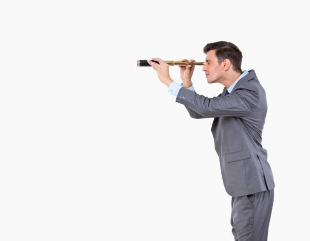 istock Businessman looking through spyglass 1208822290