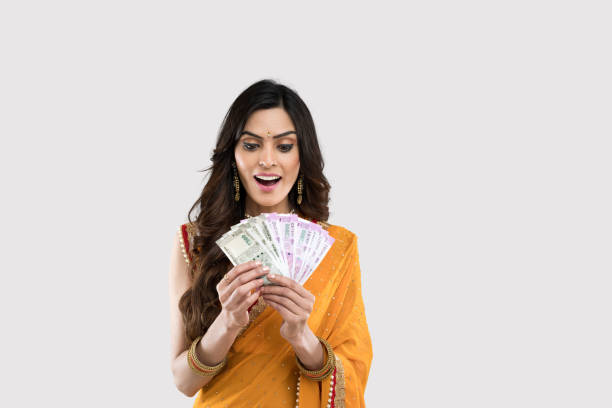istock Surprised woman holding Indian paper currency 1208822437